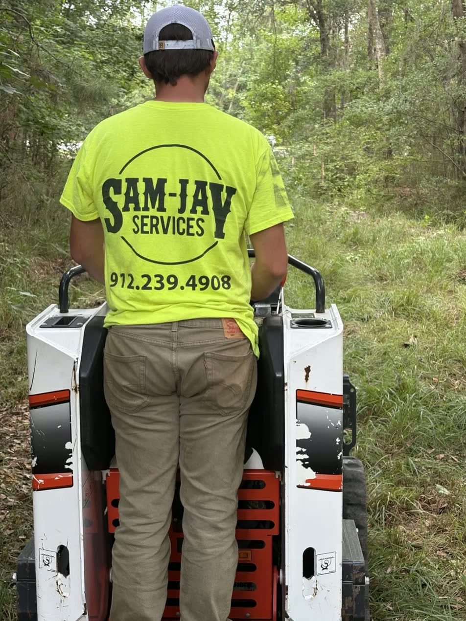 Sam-Jay Services crew operating a compact track loader on a land clearing job