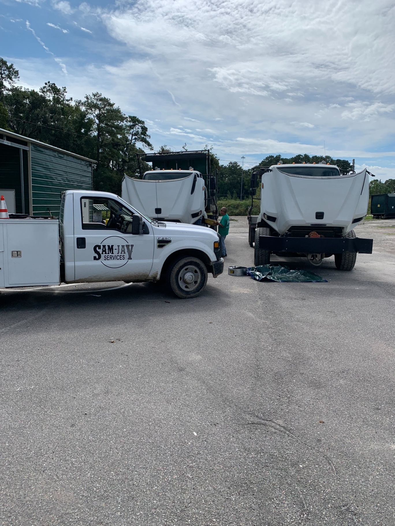 Sam-Jay Services service truck and heavy equipment at the yard