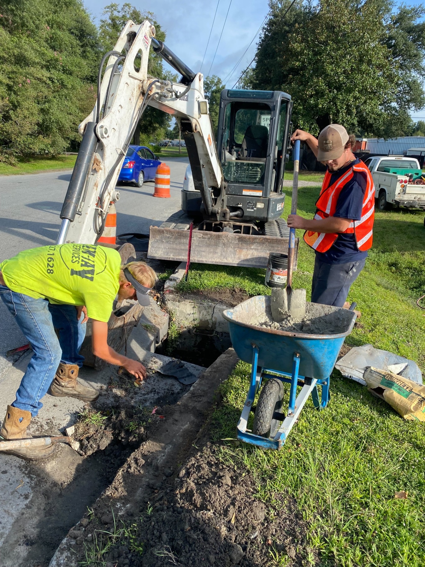 Sam-Jay crew repairing stormwater infrastructure with mini excavator